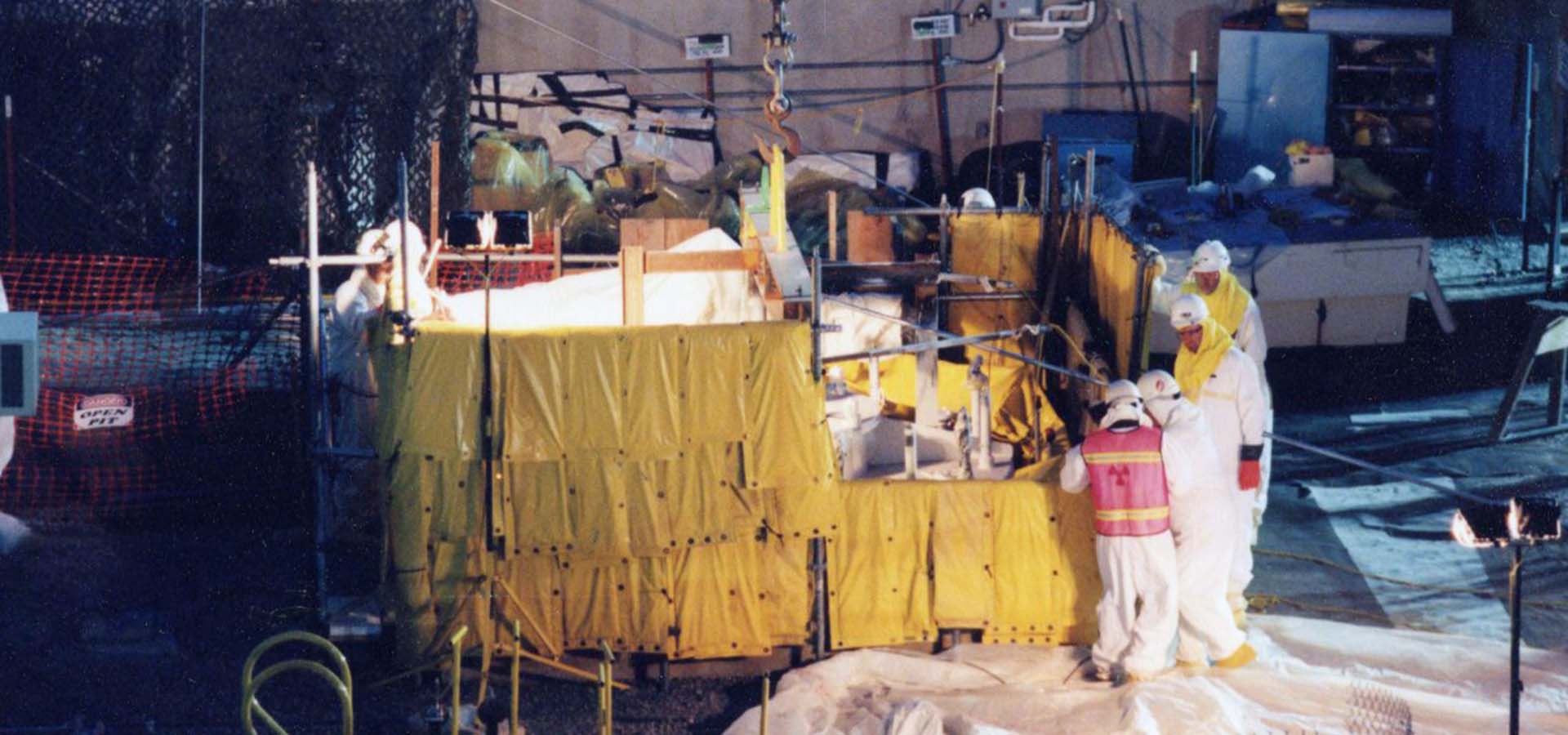 Workers in protective suits cleaning up a nuclear site.