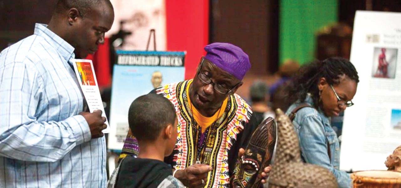 African Americans talking about their shared history at an exhibition.