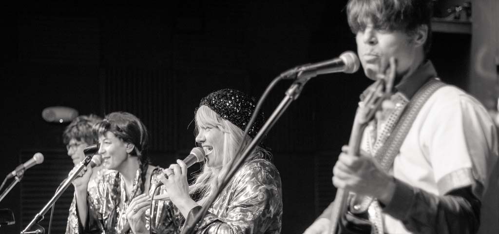 Black and white photo of an ABBA cover band, The ABBAgraphs.