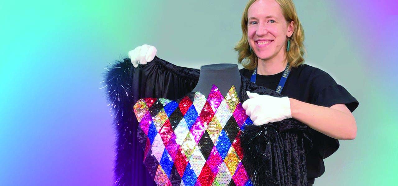 Woman putting a fur over a sequined dress.