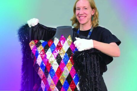 Woman putting a fur over a sequined dress.