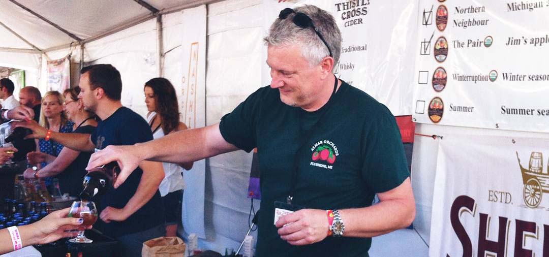 Man pouring cider into tasting cups.