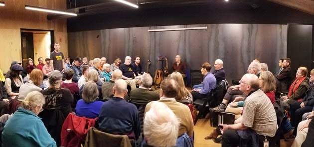 People gathered in a room to sing together.