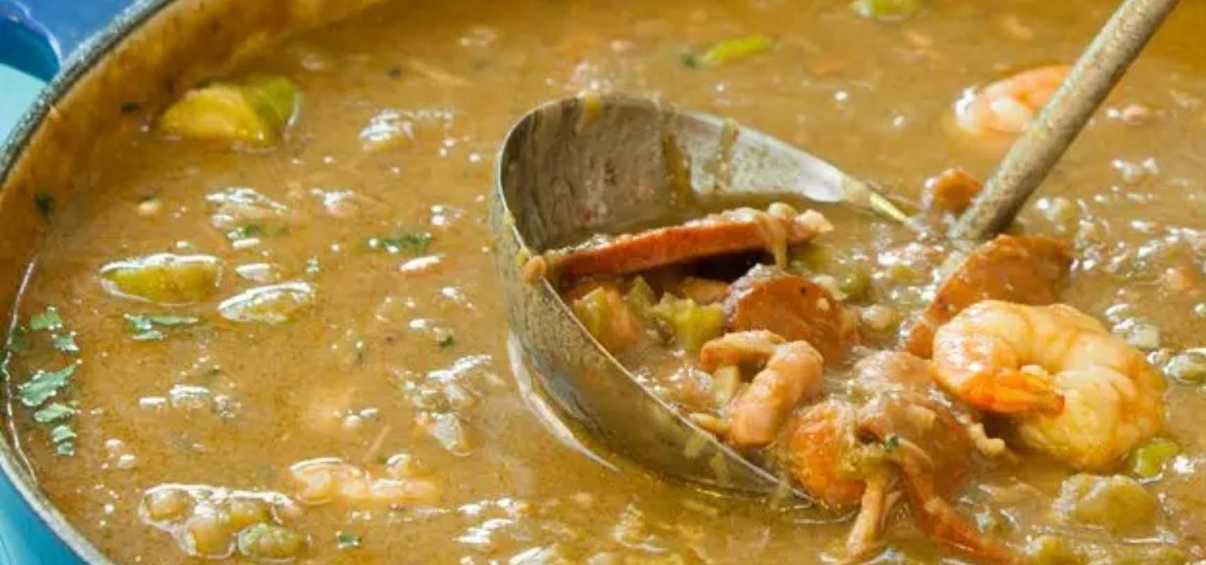 Ladle spooning a serving from a pot of Étouffée.