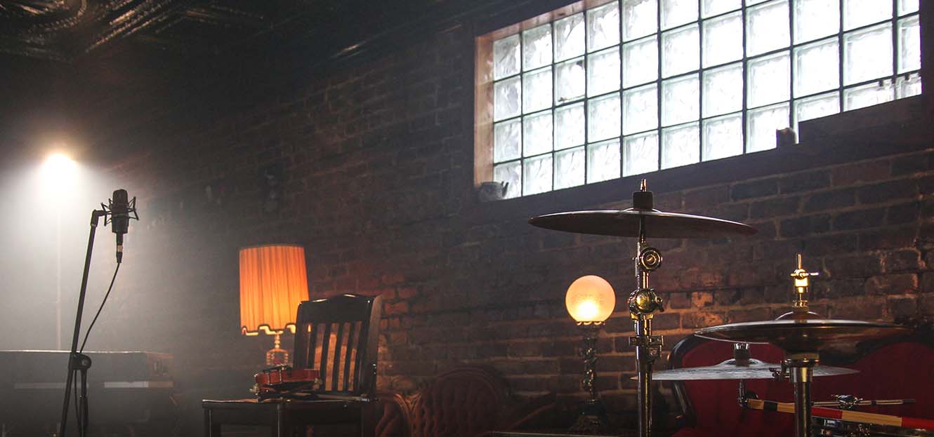 Dark room with instruments highlighted by a window's light.