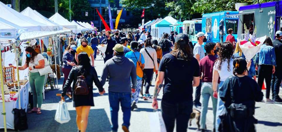 People walking at a farmer's market.