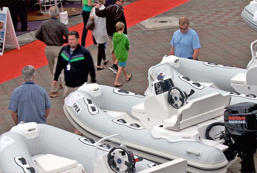 People looking at float craft on a dock.