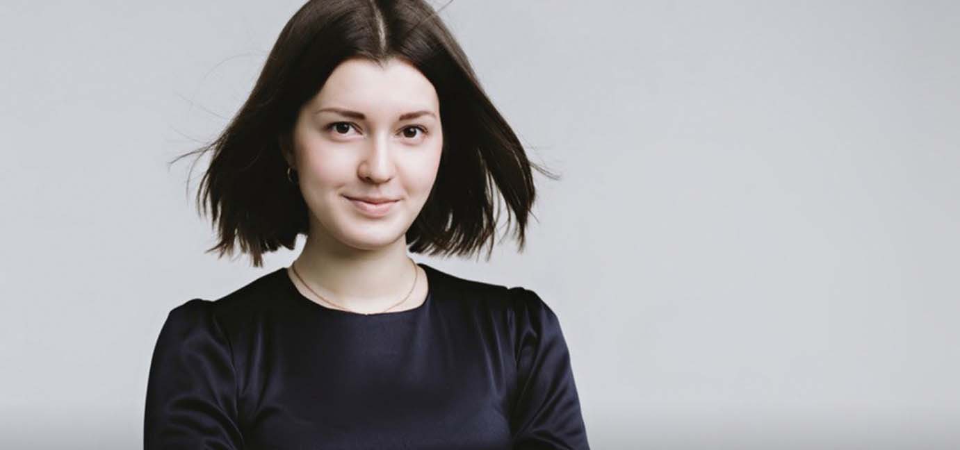 Women in black dress smiling for the camera.