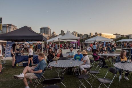 People enjoying a cider festival outside.