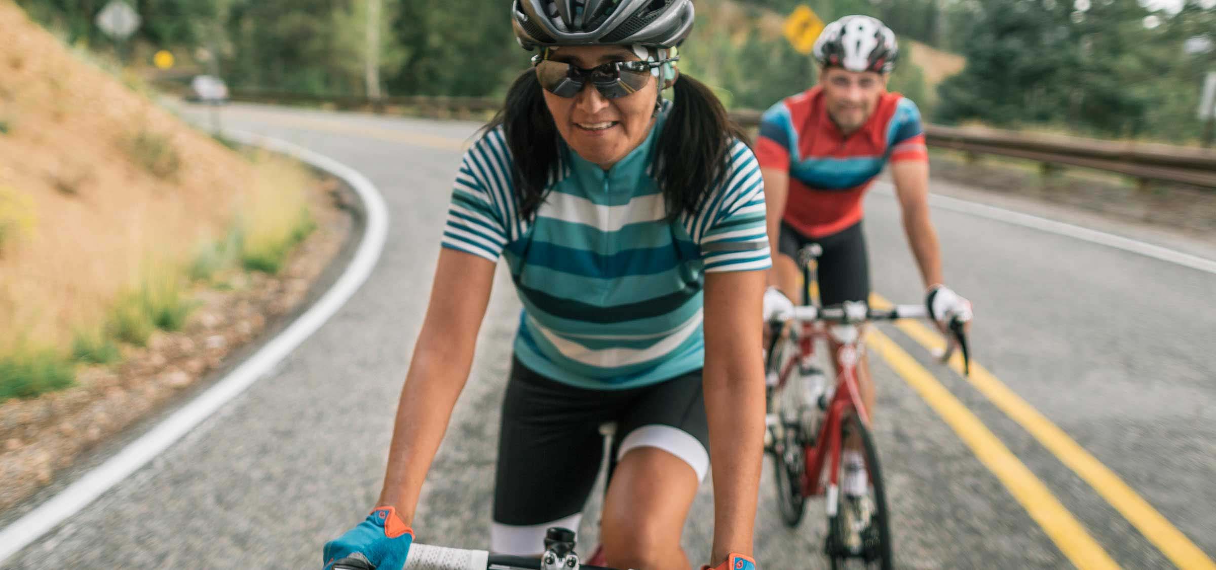 Two people riding bicycles.