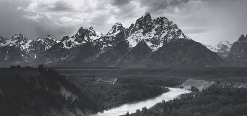 Black and white photograph by Ansel Adams of the Grant Tetons.