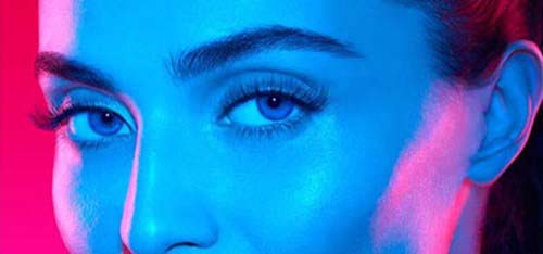Photo of a women's face in neon lights.
