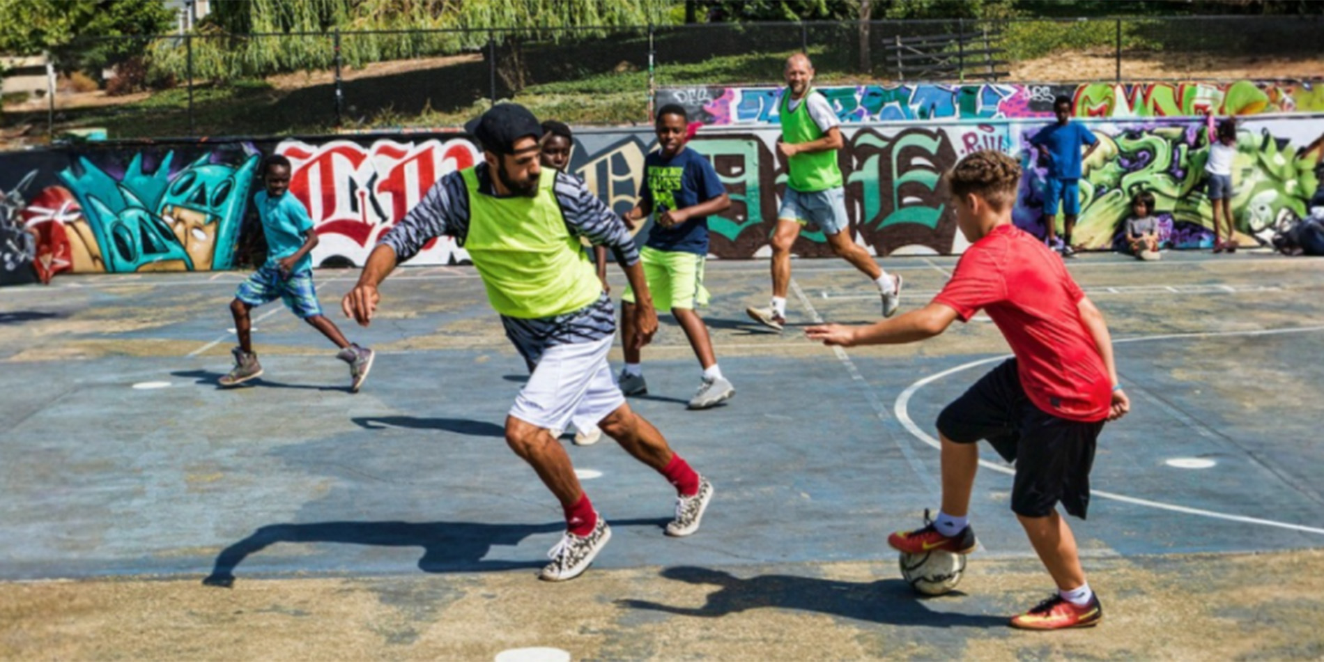 adults and kids playing soccer