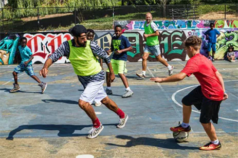 adults and kids playing soccer