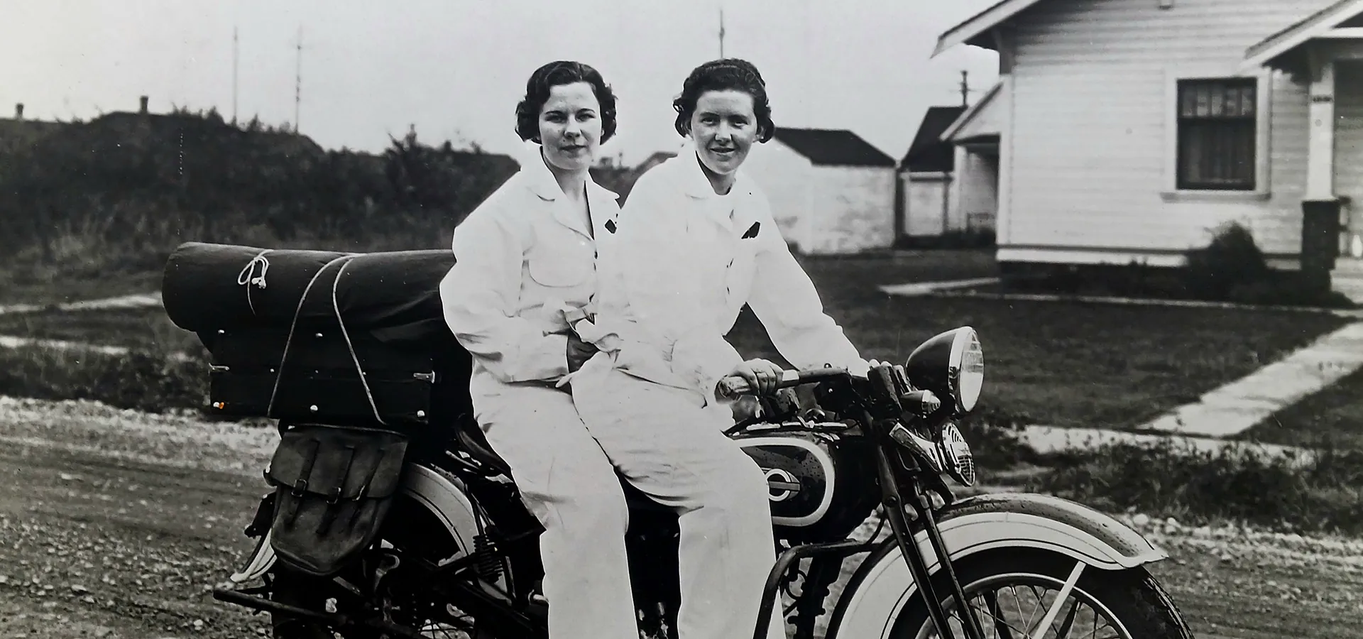 vintage photo of two women on a motorcycle