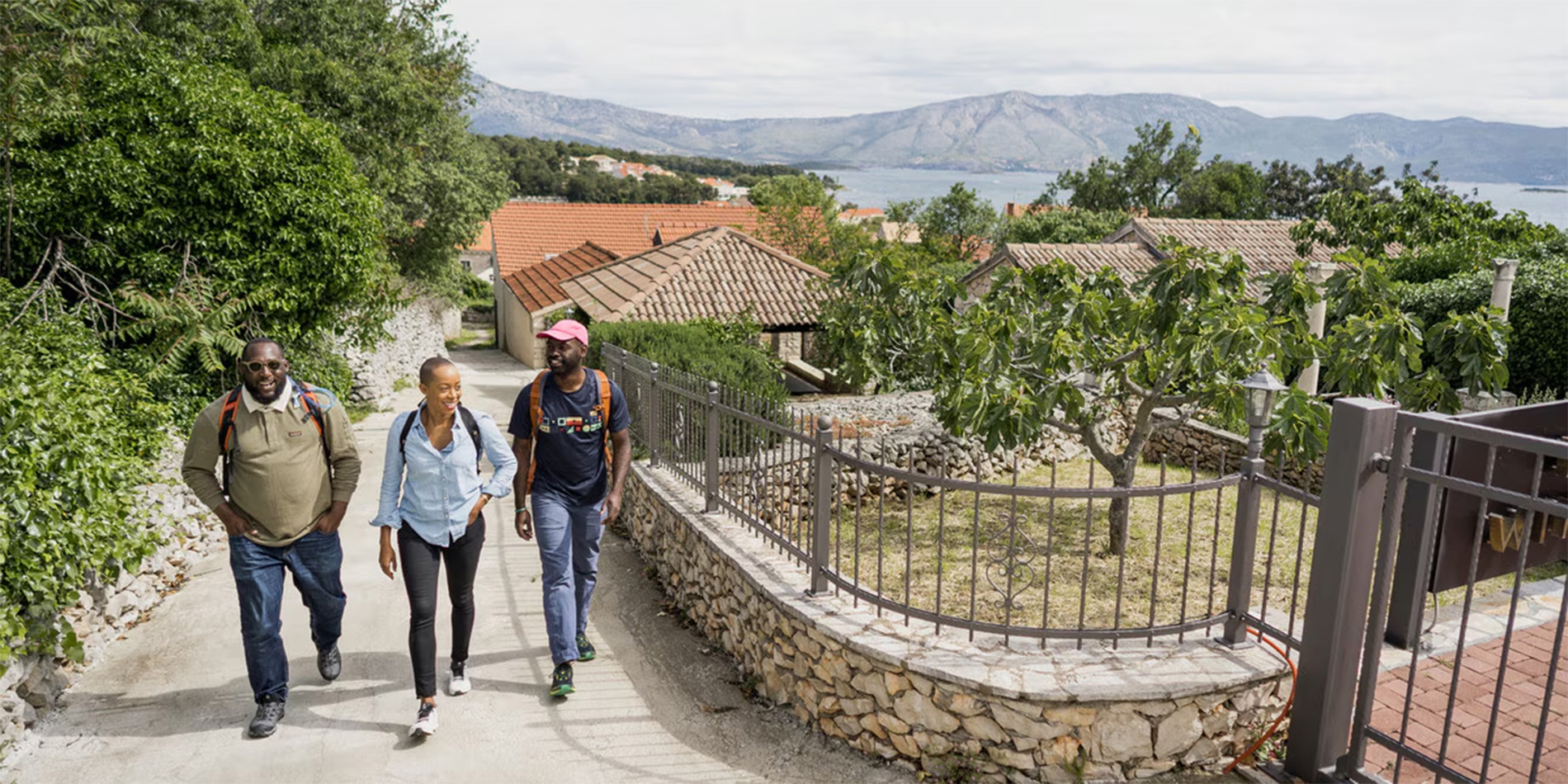 three people walking up path