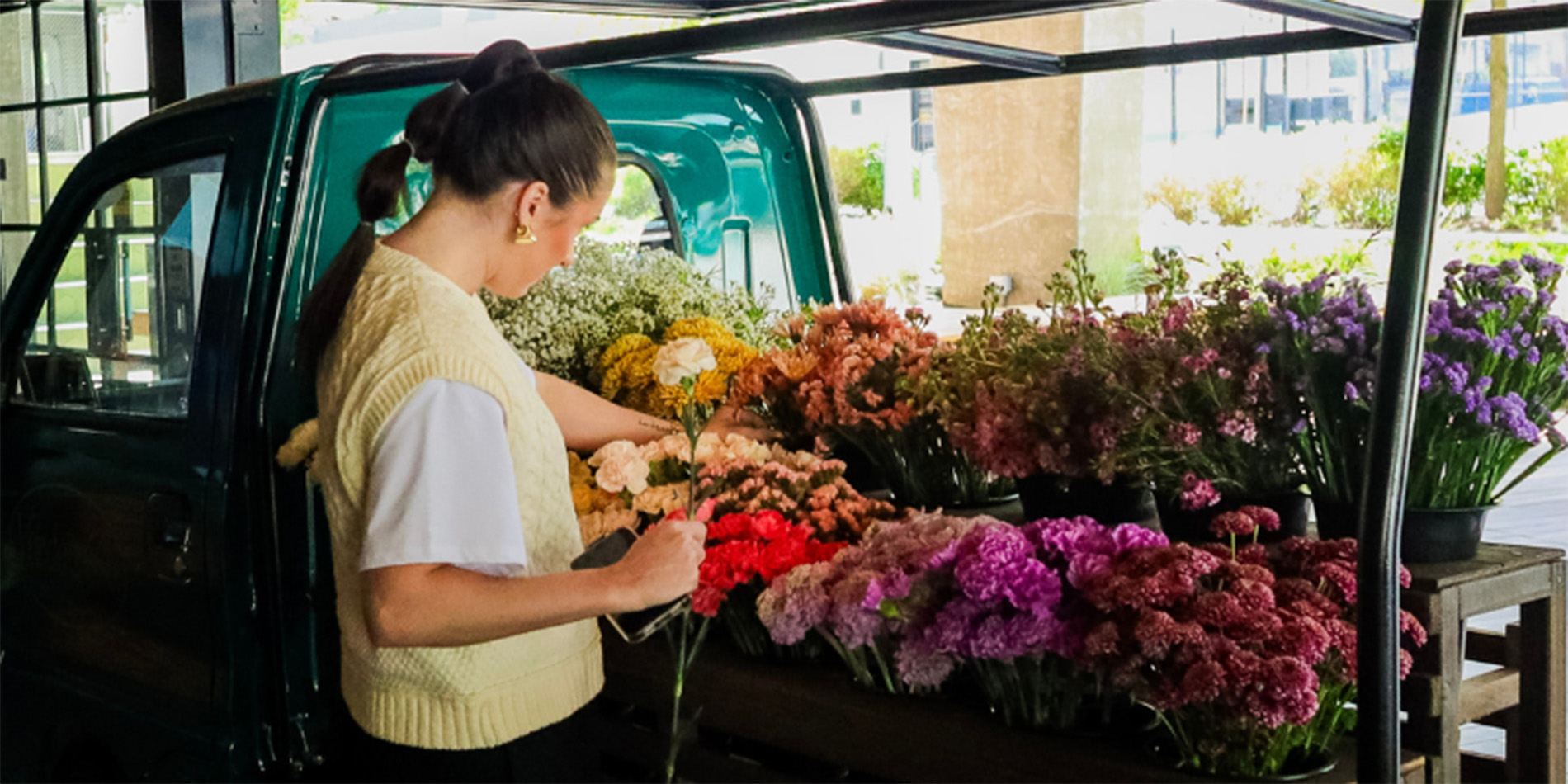 woman with flowers in truck bed