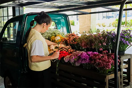 woman with flowers in truck bed