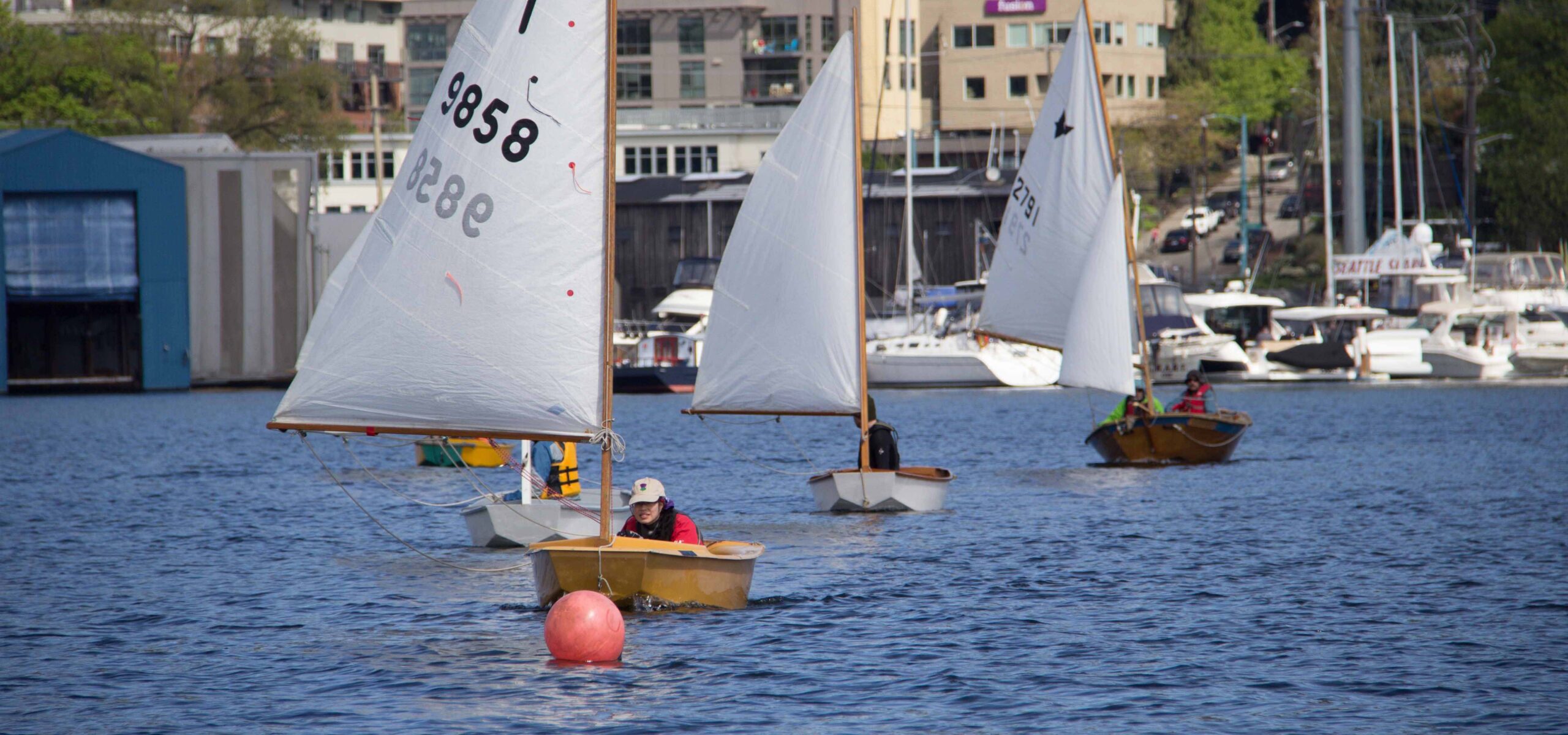 Photo of small water craft racing on a lake.