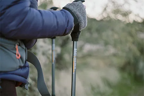 person walking with trekking poles