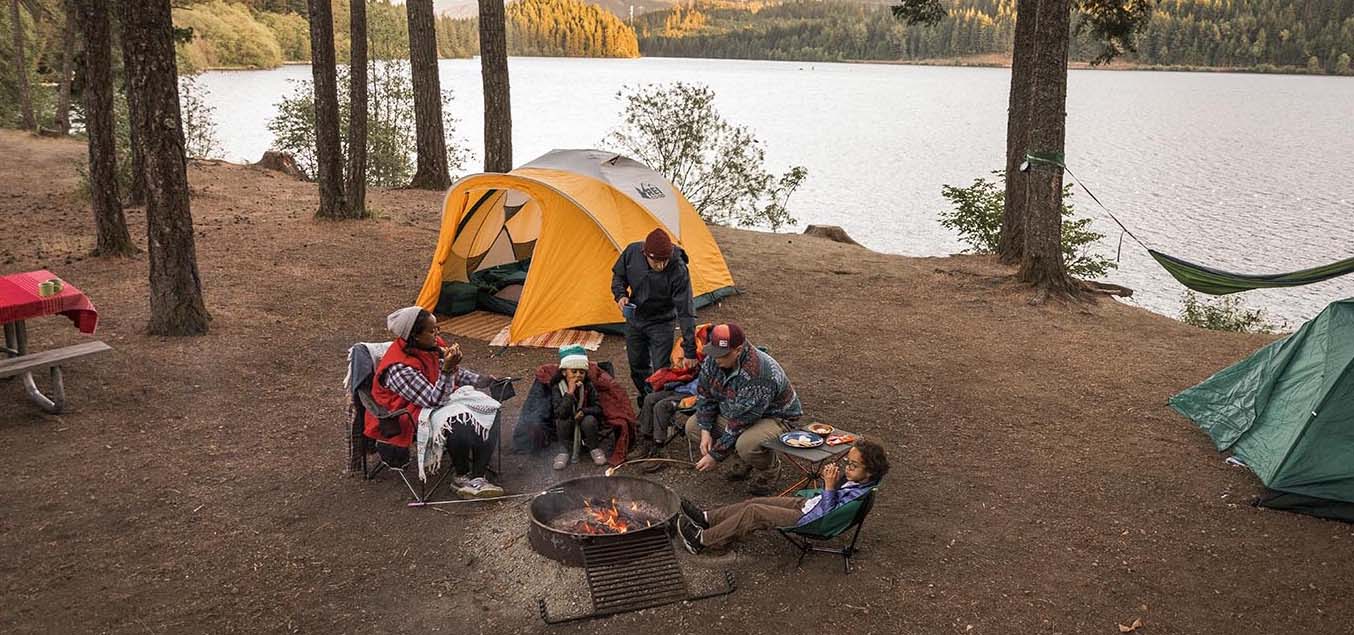 Group of friends camping by a lake.