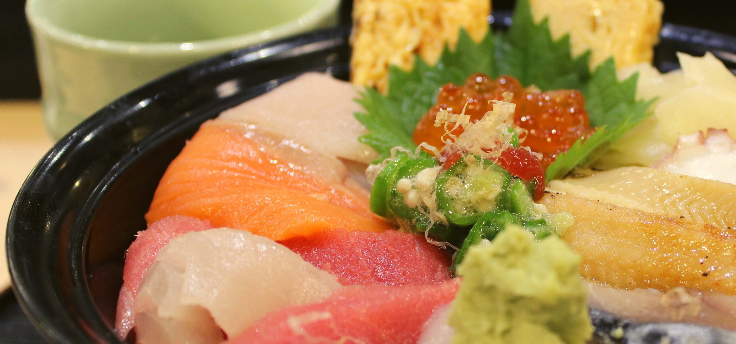 Japanese chirashi bowl filled with different fish and toppings.