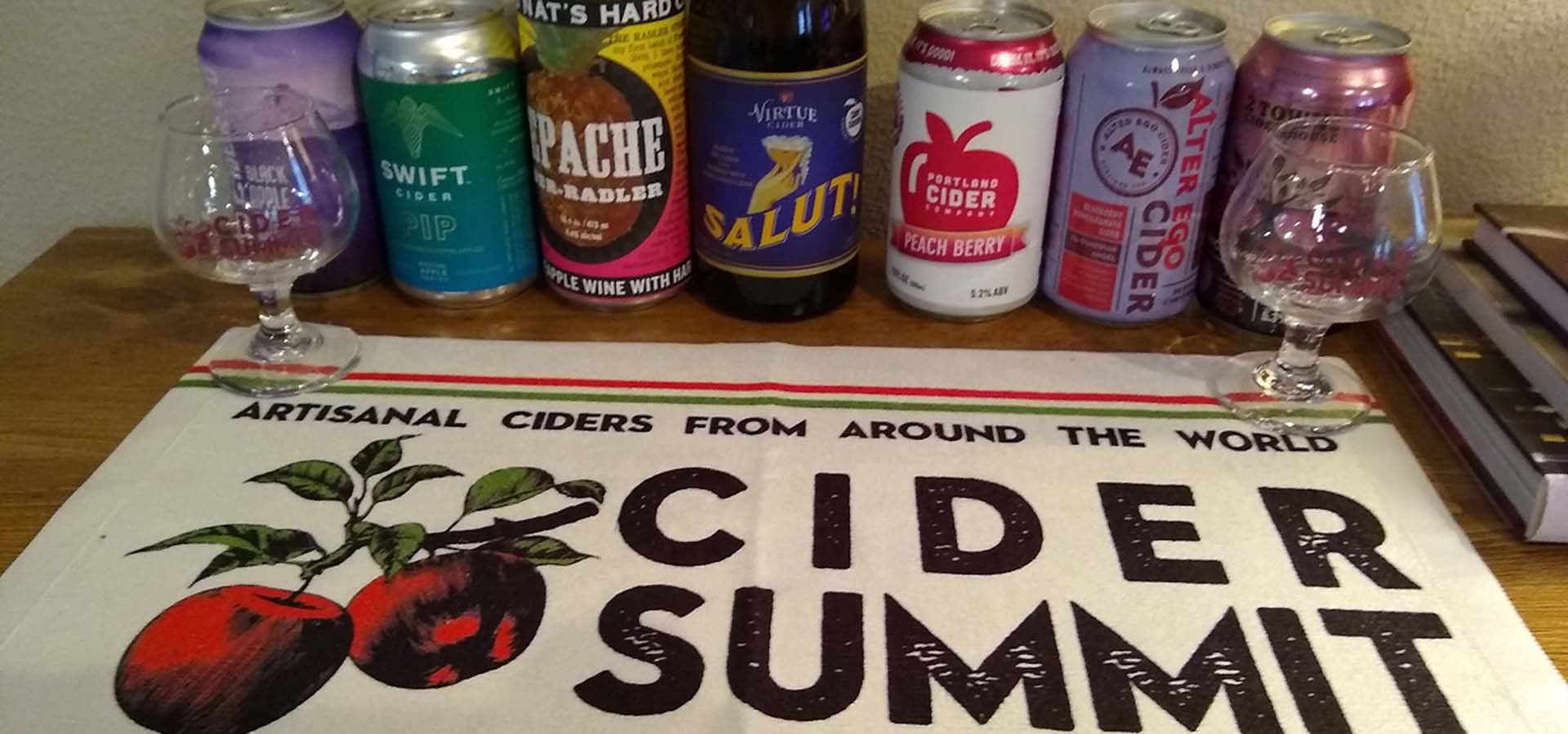 Seattle Cider Summit tasting kit offering; includes a bar towel with logo, 2 tasting glasses, and various ciders.