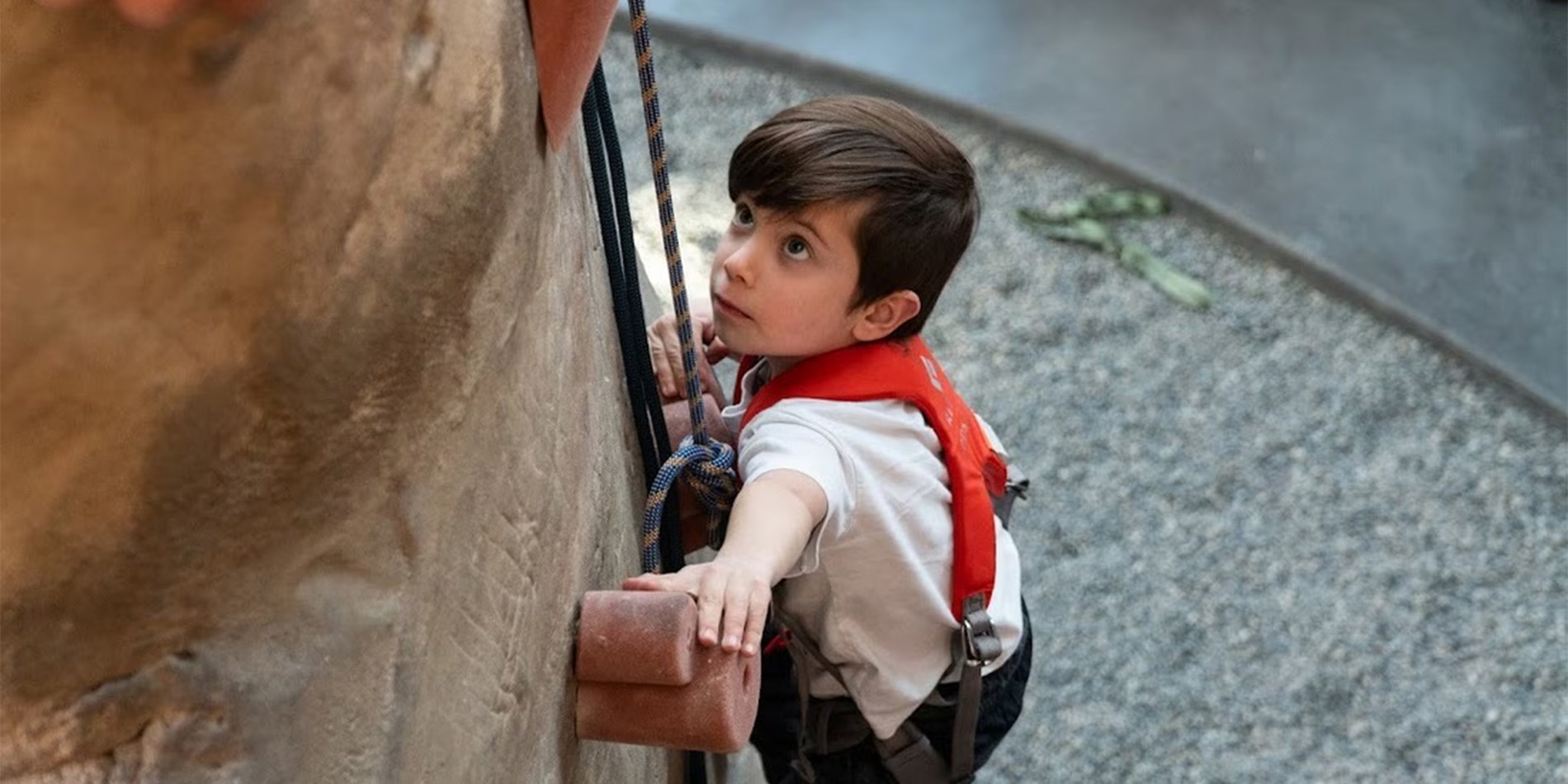 kid climbing rock wall