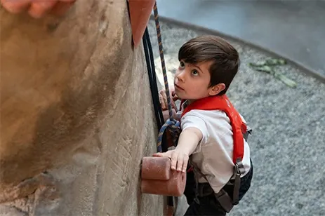 kid climbing rock wall