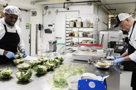 two workers in kitchen