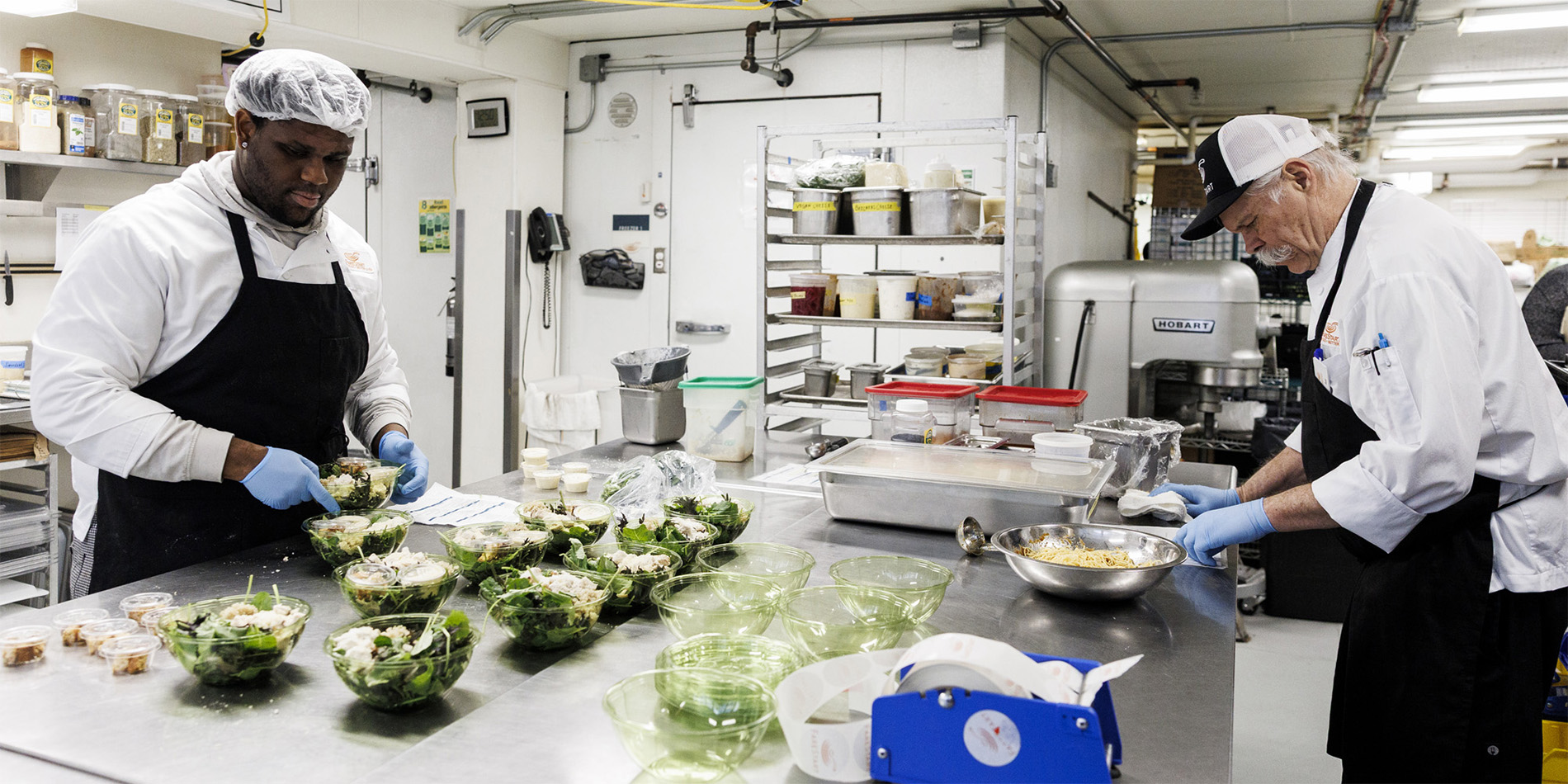 two workers in kitchen