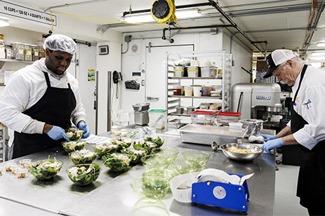 two workers in kitchen