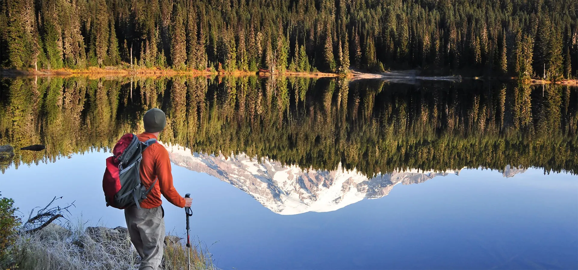 hiker in front of lake