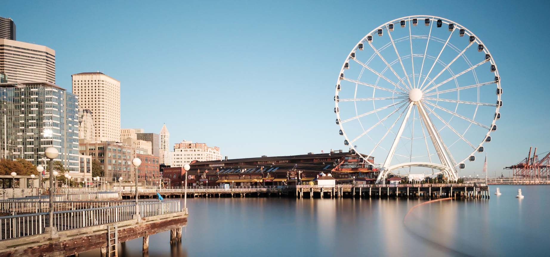 Photograph of ferris wheel on a city dock.