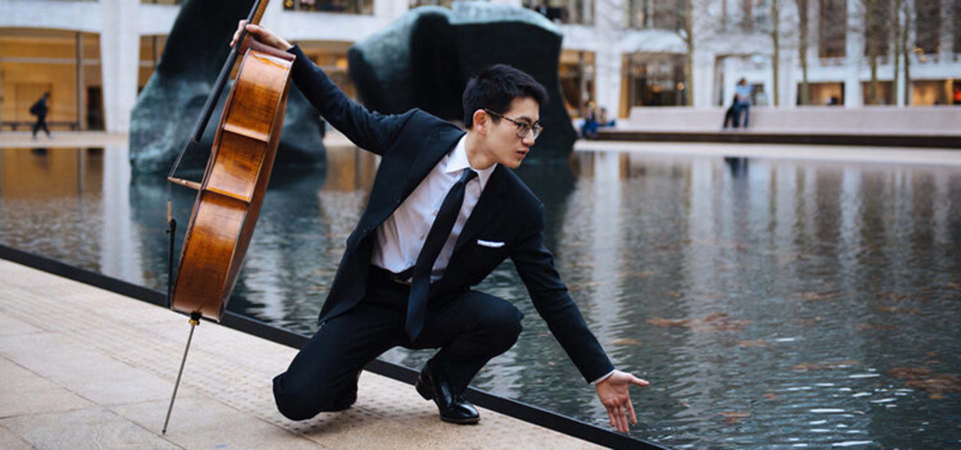 Cello playing touching a pool of water