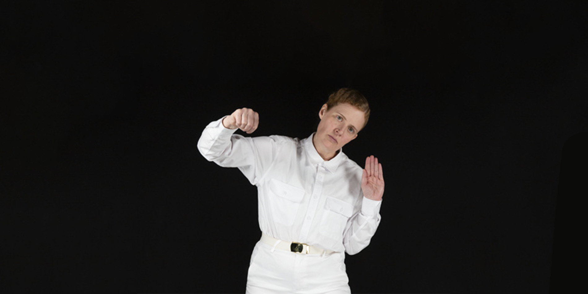 person posing against black background