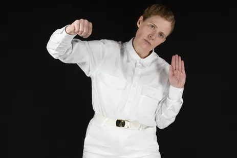 person posing against black background