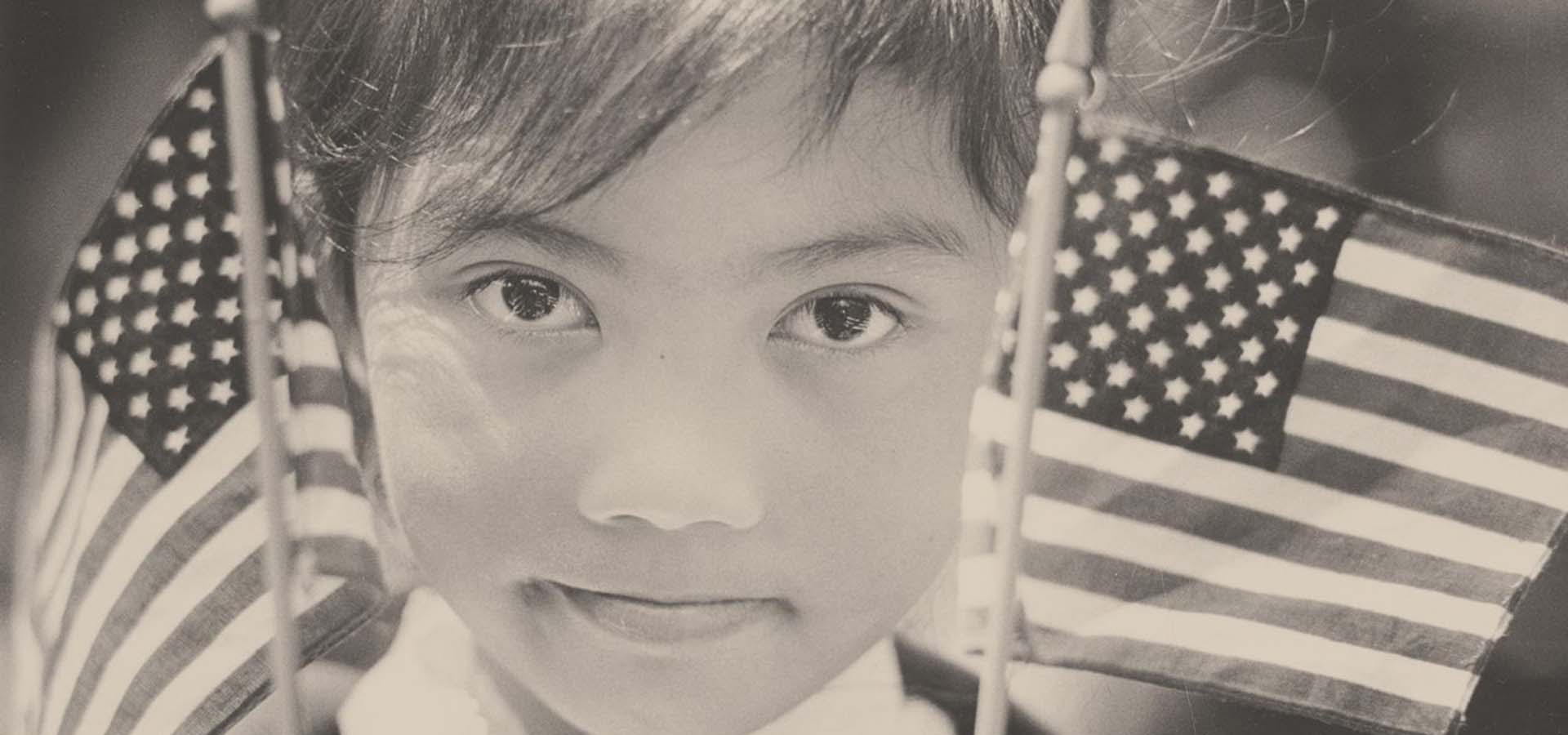 Young girl holding American flags