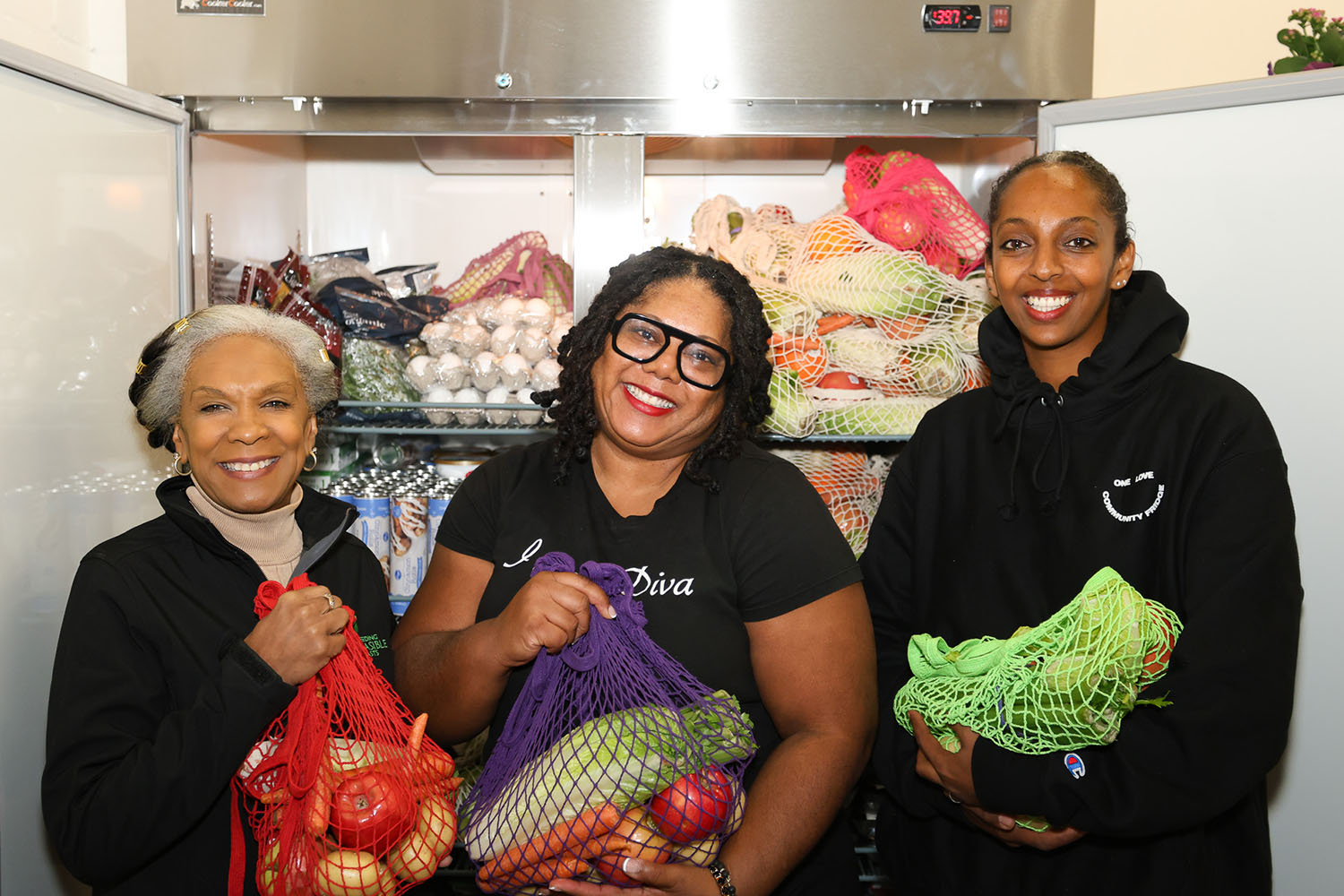 three women in front of food pantry