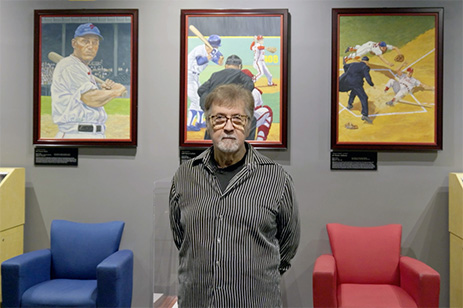 Dick Perez in front of paintings