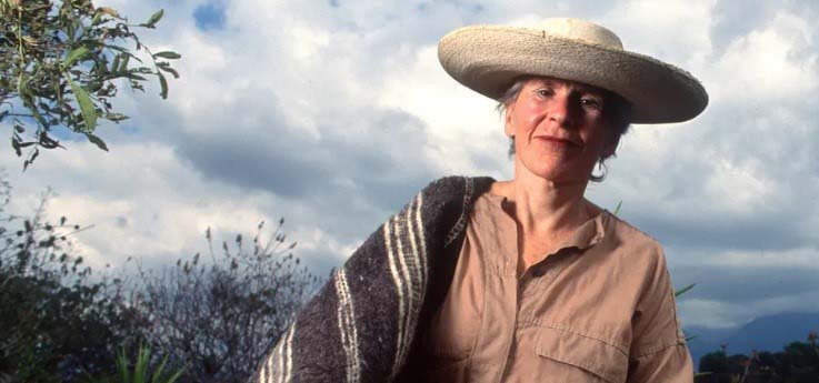 Photo of Diana Kennedy, author, in Mexico with a basket of vegetables.