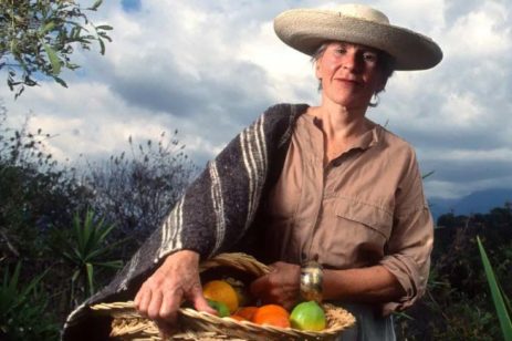 Photo of Diana Kennedy, author, in Mexico with a basket of vegetables.