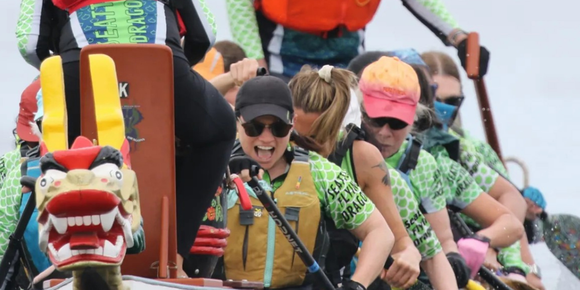 people rowing in dragon boat