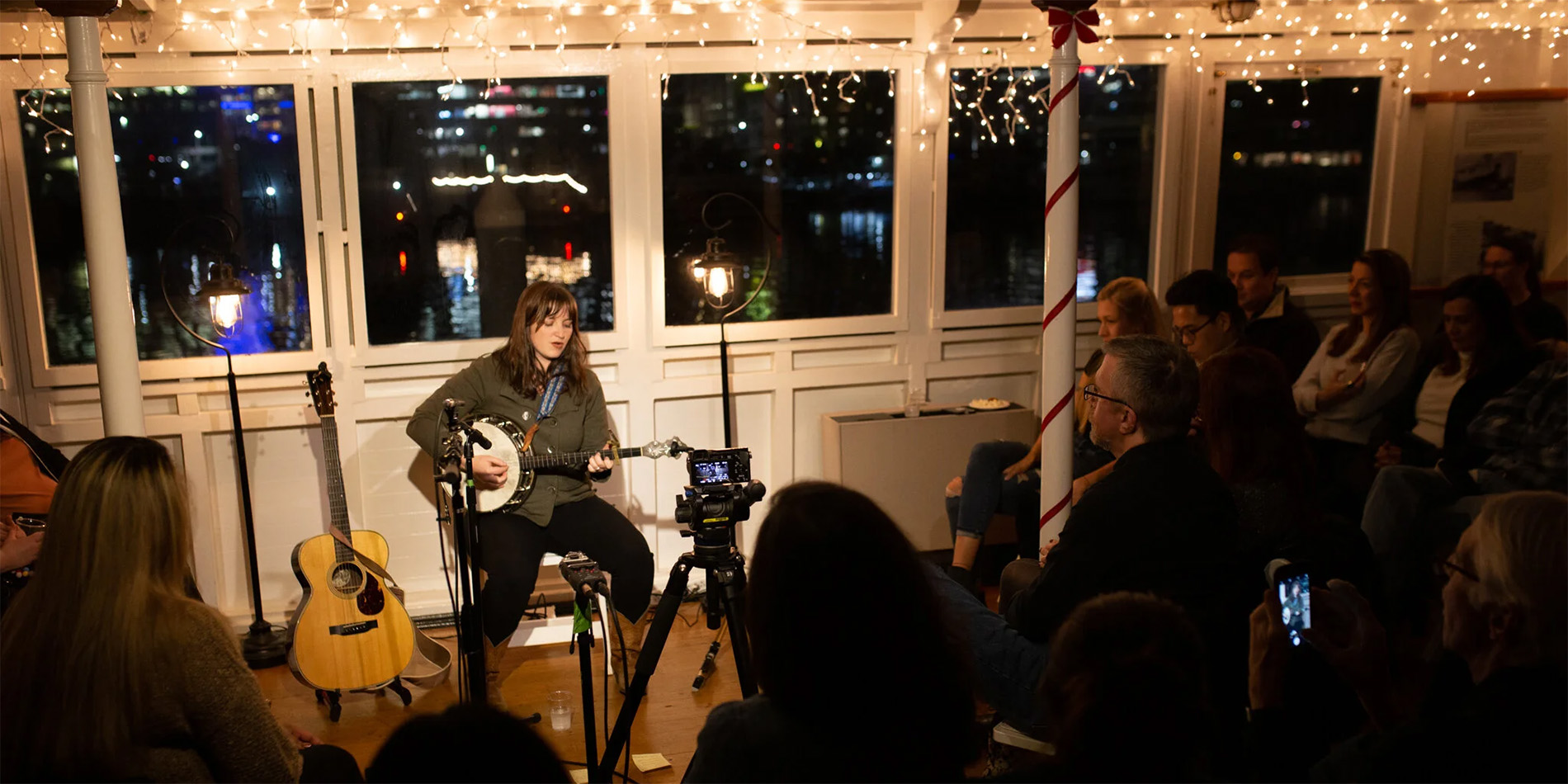 person playing guitar and singing