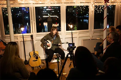 person playing guitar and singing
