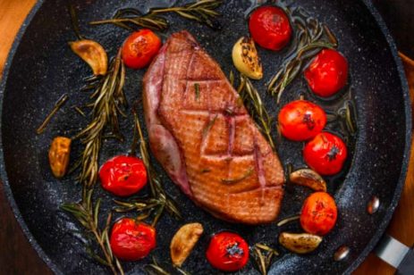Seared duck breast with tomatoes.