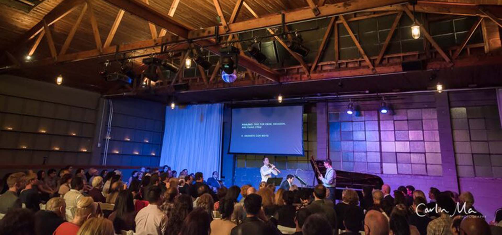 Music hall with audience listening to a singer