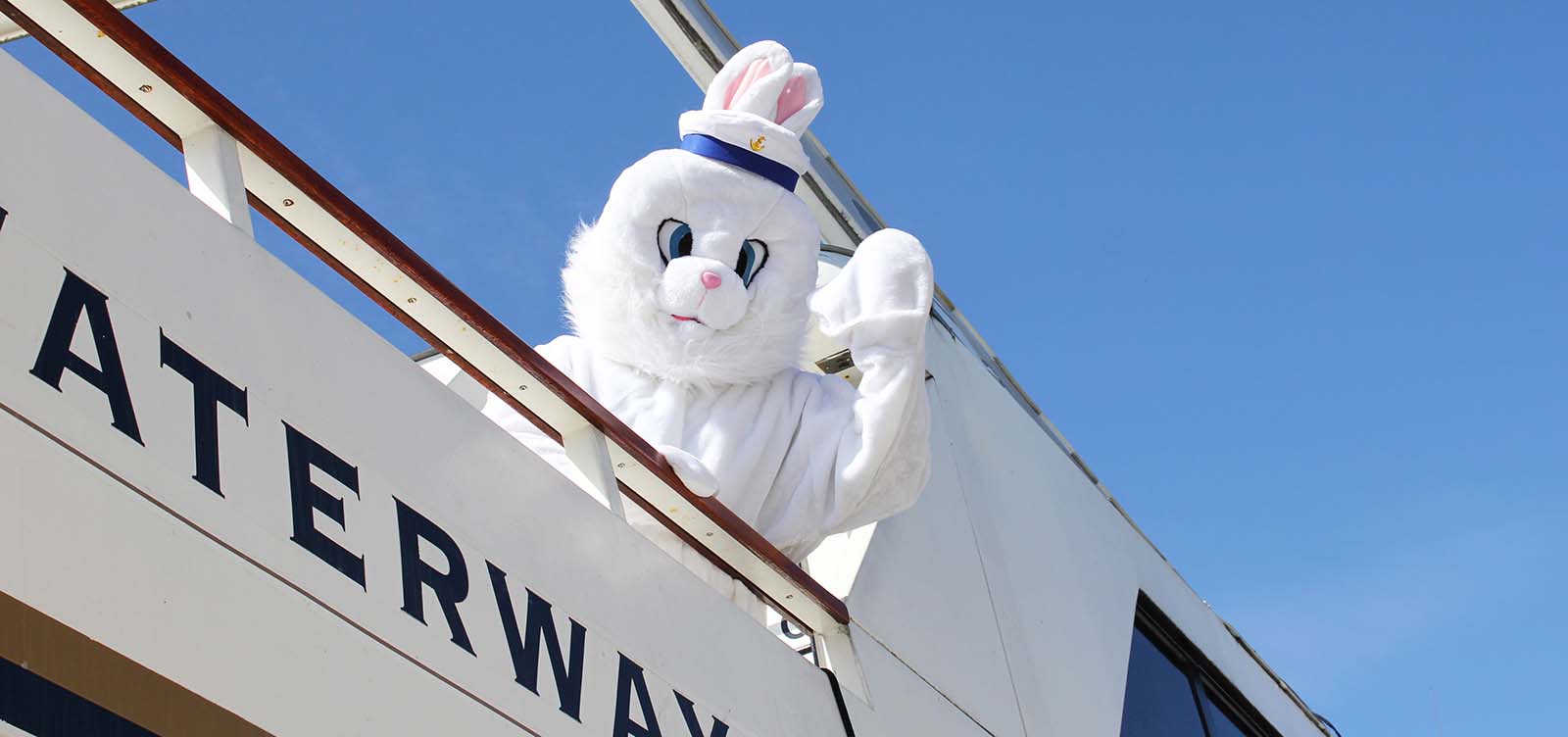 Easter bunny waving from a yacht.