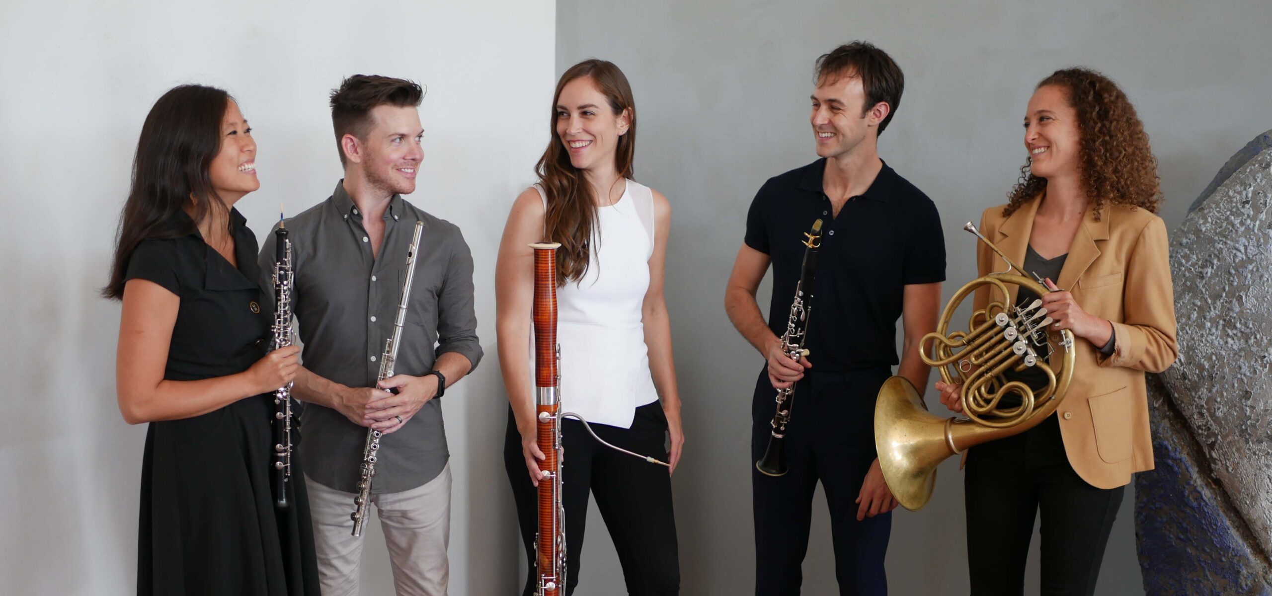 A group of performers holding their musical instruments.