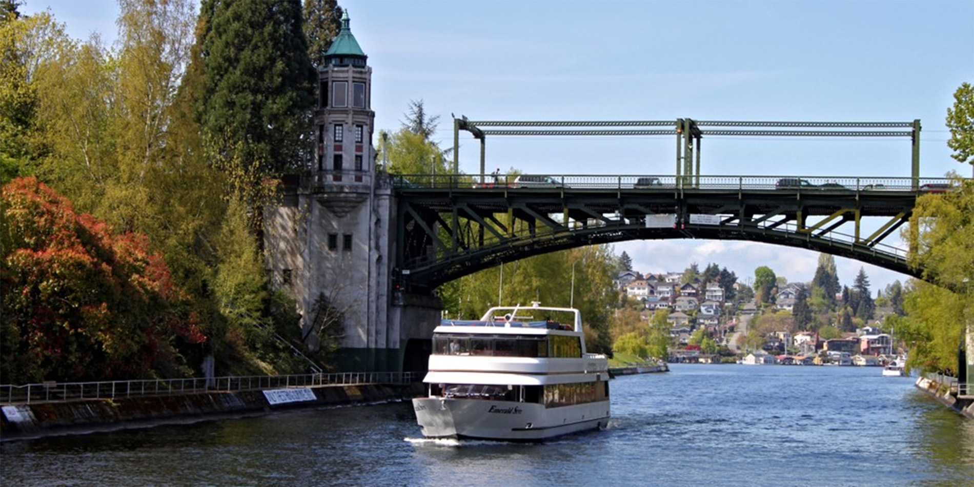 cruise boat under bridge